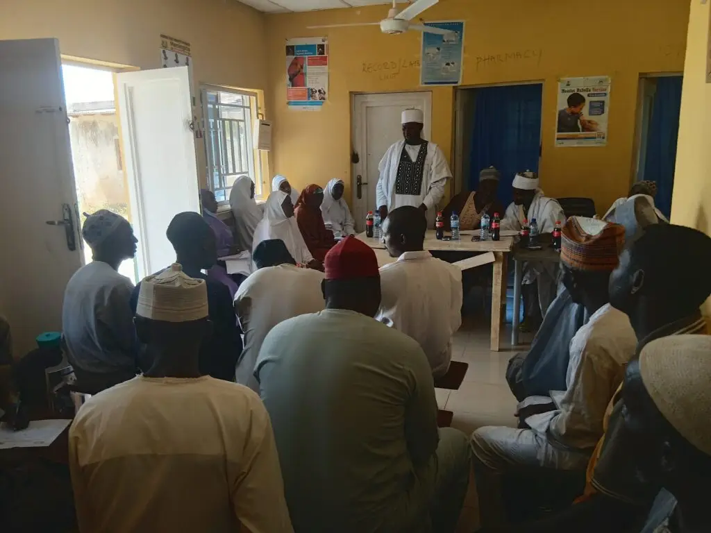 Community members seated in rows at the Gabari town hall meeting in Zaria, Kaduna