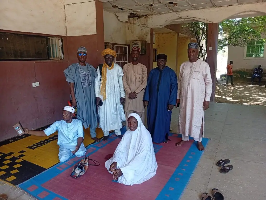 Members of the Dala LHAART standing and seated together after their monthly meeting in Dala, Kano