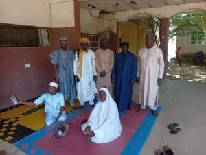 Members of the Dala LHAART standing and seated together after their monthly meeting in Dala, Kano