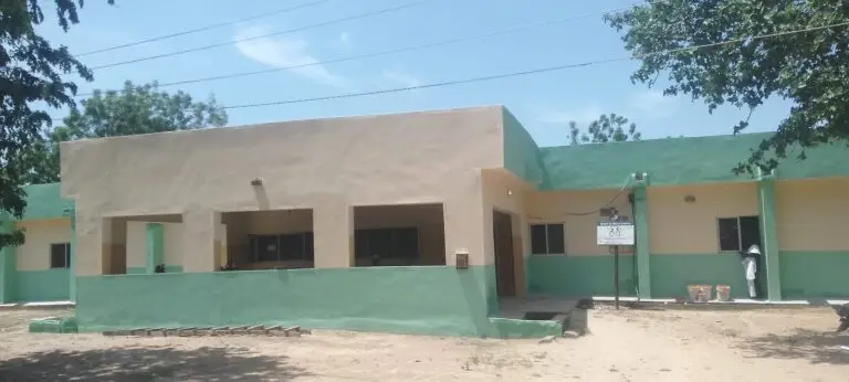 Front of a renovated primary health centre painted cream and green in Wudil, Kano