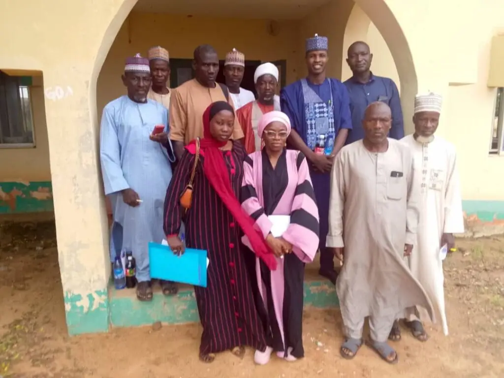 LHAAT members standing at the entrance of a primary health centre in Augie, Kebbi