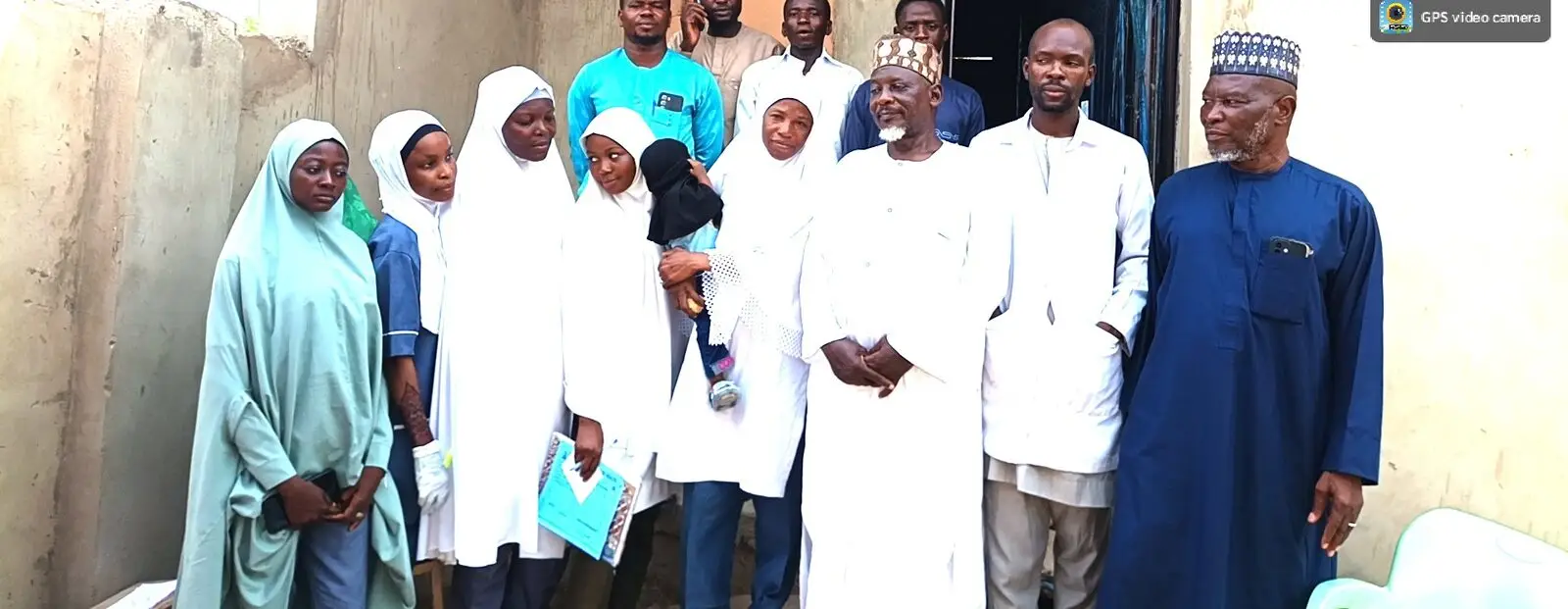 Community members and LHAAT members standing together outside a health facility at Tugan Maizari, Yauri, Kebbi